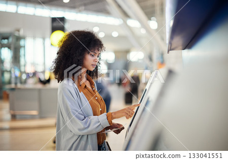 Black woman, airport and self service station for ticket, registration or online boarding pass. African American female traveler by terminal machine for travel application, document or booking flight 133041551