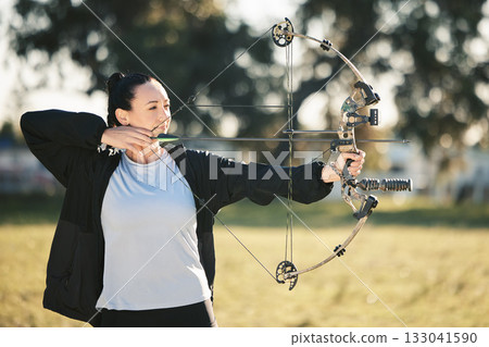 Happy person, bow or arrows aim in sports field, shooting range or gaming nature in hunting, hobby or exercise. Archery, woman or athlete smile with weapon in target training, competition or practice Happy person, bow or arrows aim in sports field, shooting range or gaming nature in hunting, hobby or exercise. Archery, woman or athlete smile with weapon in target training, competition or practice 133041590