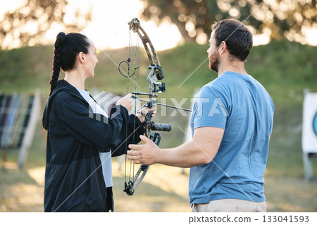 Target, training and archery woman with an instructor on field for hobby, aim and control. Arrow, practice and archer people together outdoor for hunting, precision and weapon in shooting competition Target, training and archery woman with an instructor on field for hobby, aim and control. Arrow, practice and archer people together outdoor for hunting, precision and weapon in shooting competition 133041593