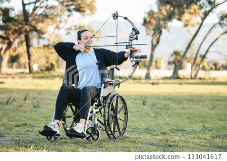 Disabled woman, outdoor archery in wheelchair and challenge with active sports lifestyle in Canada. Person with disability in a park, fitness activity to exercise arms and aim arrow for hobby 133041617