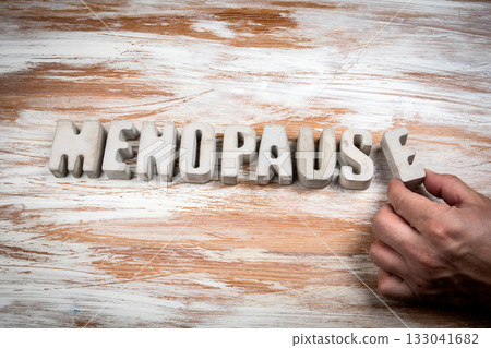Word menopause written with concrete letters on wooden background symbolizing women health aging and Word menopause written with concrete letters on wooden background symbolizing women health aging and 133041682