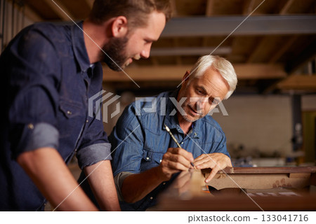 Carpentry, learning and man with apprentice in training, teaching and tips for professional furniture manufacturing. Mentorship, expert carpenter and student working at wood design project workshop. 133041716