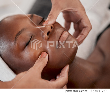 Black woman, relax massage and facial spa treatment of a young female face with serum. Skincare, beauty and wellness clinic with client feeling calm and zen from dermatology or cosmetic chemical peel Black woman, relax massage and facial spa treatment of a young female face with serum. Skincare, beauty and wellness clinic with client feeling calm and zen from dermatology or cosmetic chemical peel 133041768