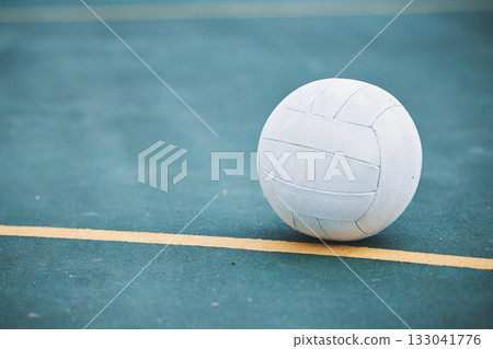 Netball on the ground on a sports court for a match, training or exercise outdoor on a field. Sport, fitness and white ball on the floor for a game, workout or practice competition by a outside arena 133041776
