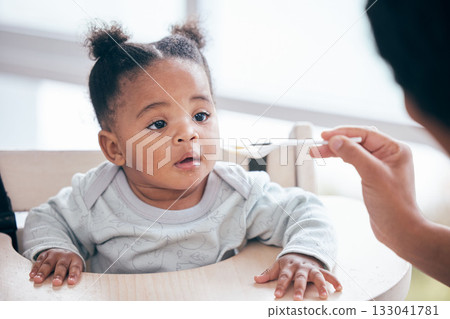 Food, breakfast and parent feeding a baby in the morning while eating porridge with a mother. Hungry, feed and African child ready to eat a meal, lunch or dinner with a mom in a family home Food, breakfast and parent feeding a baby in the morning while eating porridge with a mother. Hungry, feed and African child ready to eat a meal, lunch or dinner with a mom in a family home 133041781