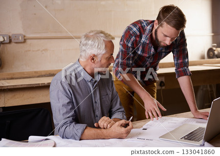 Architecture, teamwork and father and son with blueprint in workshop for collaboration on laptop. Senior engineer, men and paperwork of trainee or apprentice working on design and plan with mentor. Architecture, teamwork and father and son with blueprint in workshop for collaboration on laptop. Senior engineer, men and paperwork of trainee or apprentice working on design and plan with mentor. 133041860