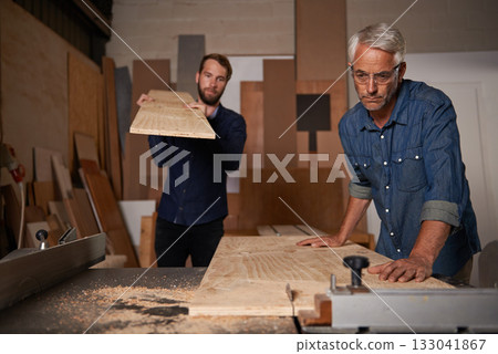 Carpentry, carpenter and men in workshop work on design project with team, vocation and creative DIY skill. Teamwork, collaboration and male employee saw wood with father and son working together Carpentry, carpenter and men in workshop work on design project with team, vocation and creative DIY skill. Teamwork, collaboration and male employee saw wood with father and son working together 133041867