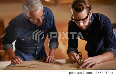 Teamwork, carpenter and apprentice in workshop, wood measurement and designer furniture manufacturing. Mentorship, carpentry and men at sustainable business, teaching and learning with design project 133041873