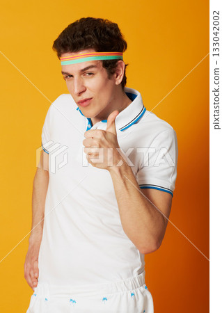 Man, sports portrait and thumbs up isolated on studio background for winning, success and like, vote or yes sign. Face of retro athlete or tennis person okay, good luck and winner hand or funny emoji 133042002