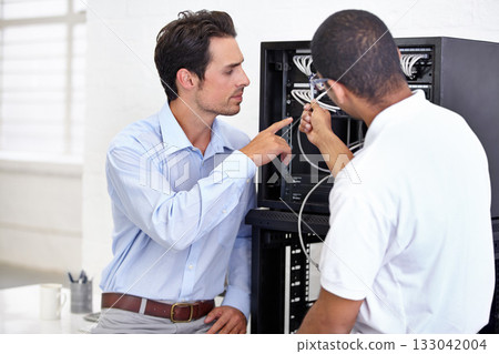 Server room, it support and pointing with a technician talking to a business man about cable connectivity. Network, database and consulting with an engineer showing a male employee a wired connection 133042004