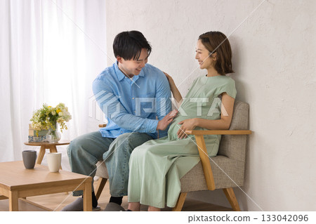 一對年輕夫婦在沙發上休息,孕婦 一對年輕夫婦在沙發上休息,孕婦 133042096