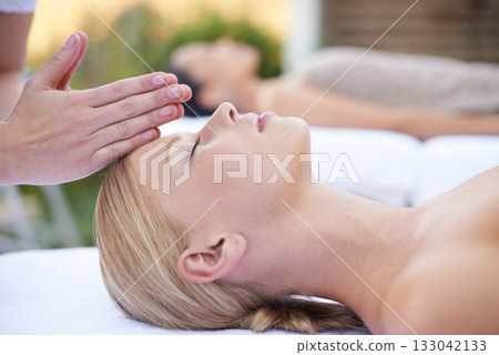 Reiki, massage and face of woman at beauty salon for health, wellness and luxury skincare treatment. Relax at spa, professional skin care and facial acupressure, healing for girl in cosmetic therapy. 133042133