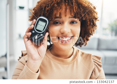 Showing, diabetes and portrait of a black woman with a machine for healthcare, test and check. Happy, medicine and African girl with a product to monitor blood sugar, health and glucose levels 133042137