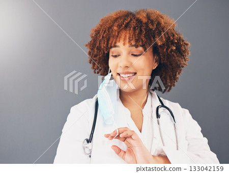 Black woman, doctor and Covid, remove face mask and health, end of pandemic and protection on studio background. Face, smile and mockup with healthcare, safety from virus and positivity with female 133042159
