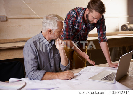 Architecture, collaboration and father and son with blueprint in workshop for building construction on laptop. Senior engineer, men and paperwork of trainee or apprentice working on design and plan. Architecture, collaboration and father and son with blueprint in workshop for building construction on laptop. Senior engineer, men and paperwork of trainee or apprentice working on design and plan. 133042215