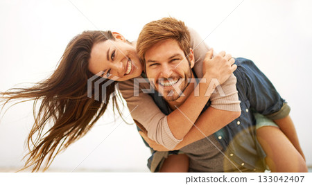 Love, hug and portrait of couple piggyback at beach, hug and laughing while bonding outdoor. Face, embrace and happy man with woman at the ocean for travel, freedom or vacation, holiday or Miami trip Love, hug and portrait of couple piggyback at beach, hug and laughing while bonding outdoor. Face, embrace and happy man with woman at the ocean for travel, freedom or vacation, holiday or Miami trip 133042407