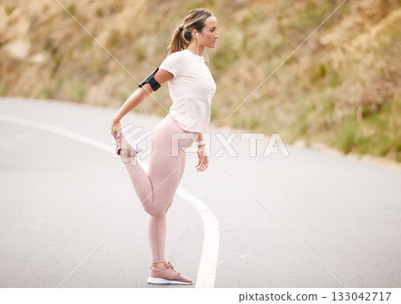 Runner, leg stretch and woman in a road with music for fitness, cardio and mindset preparation. Girk, stretching and nrunning in nature with podcast, radio or wellness motivation track for workout 133042717