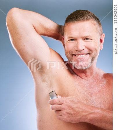 Electric razor, senior man armpit and portrait of an elderly model smile for grooming wellness and shave. Hygiene, cleaning and body hair maintenance of a person in isolated blue background studio Electric razor, senior man armpit and portrait of an elderly model smile for grooming wellness and shave. Hygiene, cleaning and body hair maintenance of a person in isolated blue background studio 133042901