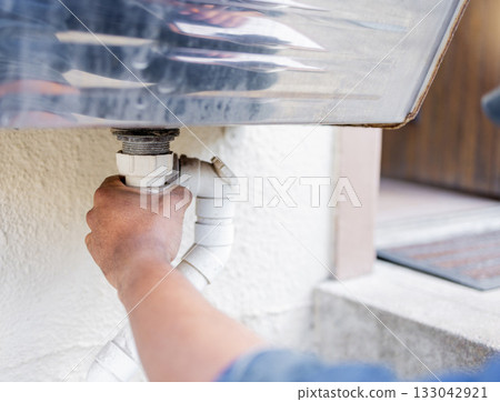 Handyman, plumber hands and pvc pipe for water system efficiency, drain and maintenance outdoor. Diy home improvement, plumbing service and expert construction worker with building renovation job Handyman, plumber hands and pvc pipe for water system efficiency, drain and maintenance outdoor. Diy home improvement, plumbing service and expert construction worker with building renovation job 133042921