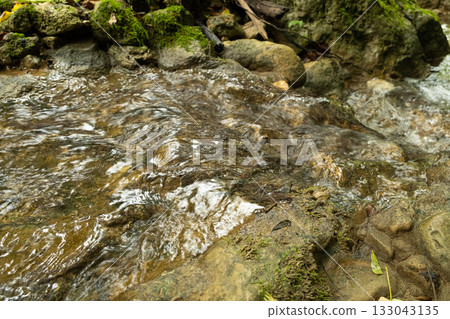 Tranquil Mountain Stream Flowing Over Rocks Tranquil Mountain Stream Flowing Over Rocks 133043135