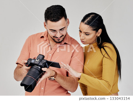 Teamwork, photographer and startup with camera in studio for shoot, magazine project or online content review. Digital agency, collaboration or people working on marketing or advertising campaign 133043154