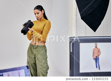Serious, photographer and woman with camera in studio for shoot, magazine project or online content. Backstage, focus or girl videographer thinking for digital web fashion design or creative career 133043155