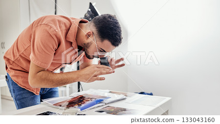 Photography, editing and man photographer in a studio working on fashion or creative images. Art, creativity and male analyzing pictures from a photoshoot at a digital, design or production agency. 133043160