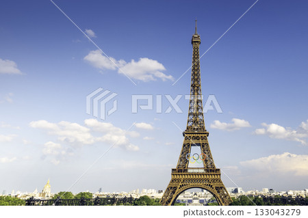 PARIS, FRANCE - JUNE 20 2024: The Olympic Rings installed on the Eiffel Tower ahead of the Paris 2024 Olympic Games PARIS, FRANCE - JUNE 20 2024: The Olympic Rings installed on the Eiffel Tower ahead of the Paris 2024 Olympic Games 133043279