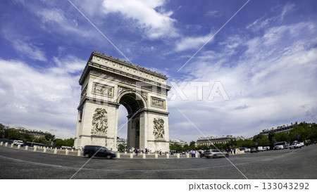 Famous Arc de Triomphe against nice blue sky Arc de Triomphe monument at Champs-elysees road in Paris, France 133043292