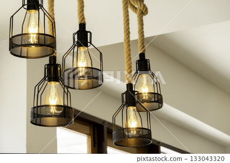 Vintage lamp hanging from the ceiling with white wall decorated in hotel Vintage lamp hanging from the ceiling with white wall decorated in hotel 133043320