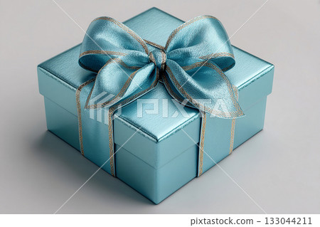Elegant present. Blue box wrapped with a bow on white background. Jewelry, birthdays, Christmas and luxury branding. Elegant present. Blue box wrapped with a bow on white background. Jewelry, birthdays, Christmas and luxury branding. 133044211