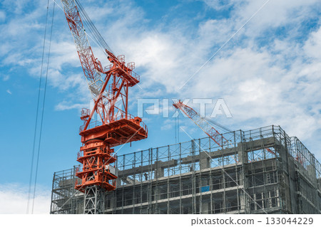 Construction site and crane against blue sky Construction site and crane against blue sky 133044229