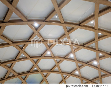 Abstract modern architecture with a wooden hexagram-shaped geometric dome ceiling Abstract modern architecture with a wooden hexagram-shaped geometric dome ceiling 133044435