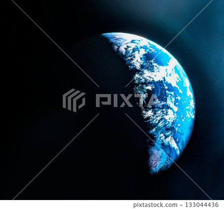 Earth floating in the darkness of space: a close-up of a hemisphere covered in blue ocean, white clouds, and shadows 133044436
