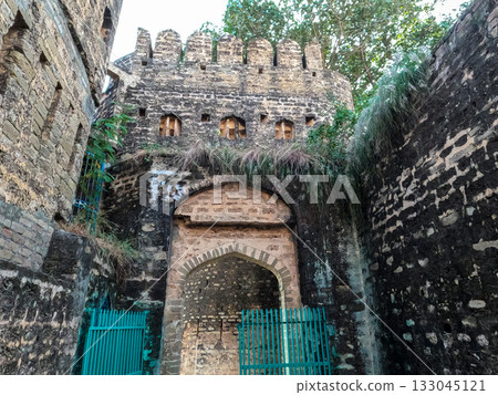 Ancient inner gate of Sangni Fort representing Mughal heritage style defense structure and traditional stone craftsmanship Ancient inner gate of Sangni Fort representing Mughal heritage style defense structure and traditional stone craftsmanship 133045121