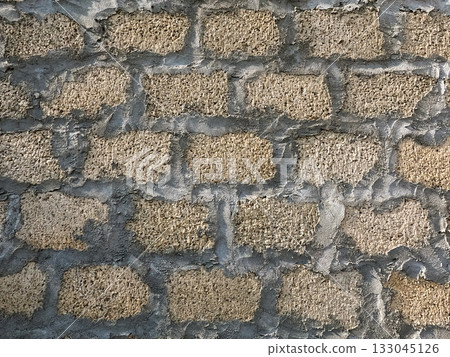 Freshly plastered cement block wall showing the final stage of construction symbolizing durability and modern housing 133045126