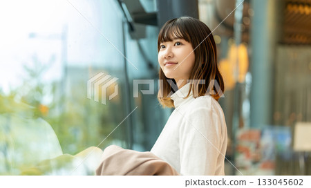 Woman looking out the window 133045602