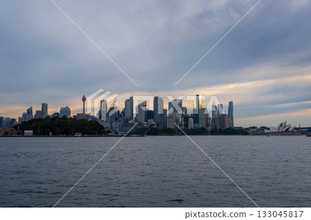 Sydney skyline at sunset with golden reflections on the water 133045817