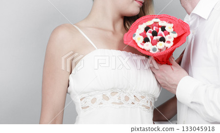 Closeup of couple with candy bunch flowers. Love. Closeup of couple with candy bunch flowers. Love. 133045918