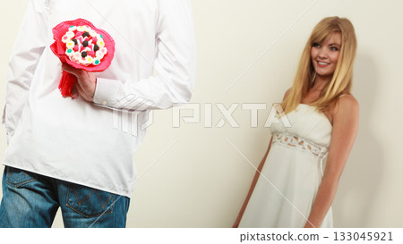 Man giving woman candy bunch flowers. Love. Man giving woman candy bunch flowers. Love. 133045921