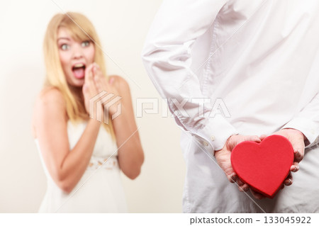 Man with heart shaped gift box for woman. Man with heart shaped gift box for woman. 133045922