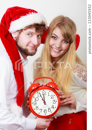 Happy couple woman and man with alarm clock. Happy couple woman and man with alarm clock. 133045932
