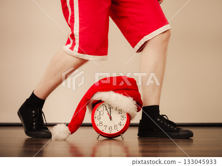 Closeup of man with alarm clock. Christmas time. Closeup of man with alarm clock. Christmas time. 133045933