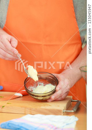 man preparing fresh salad dressing 133045947