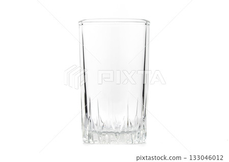 A clear glass cup sits on a white background A clear glass cup sits on a white background 133046012