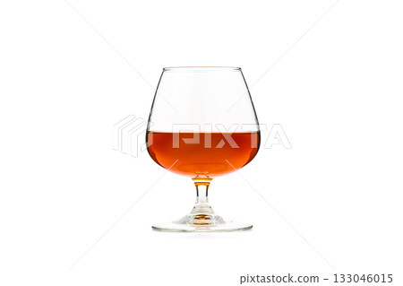 A glass of wine is sitting on a table A glass of wine is sitting on a table 133046015
