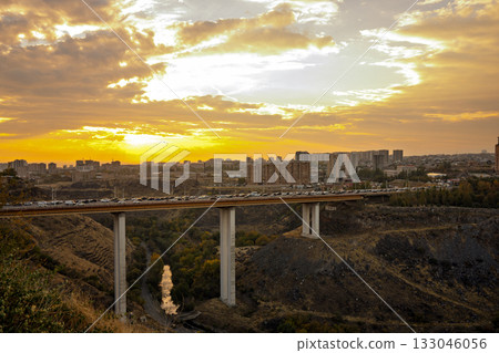 A bridge spans a river with a city in the background A bridge spans a river with a city in the background 133046056