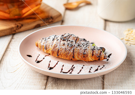 Chocolate croissant with powdered sugar 133046593