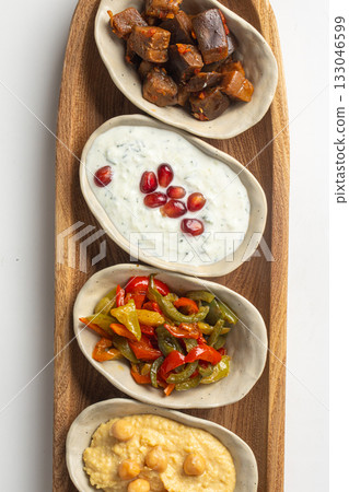 Assorted mediterranean appetizers on wooden board Assorted mediterranean appetizers on wooden board 133046599