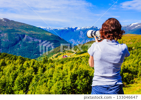 Tourist taking photo in norwegian nature 133046647